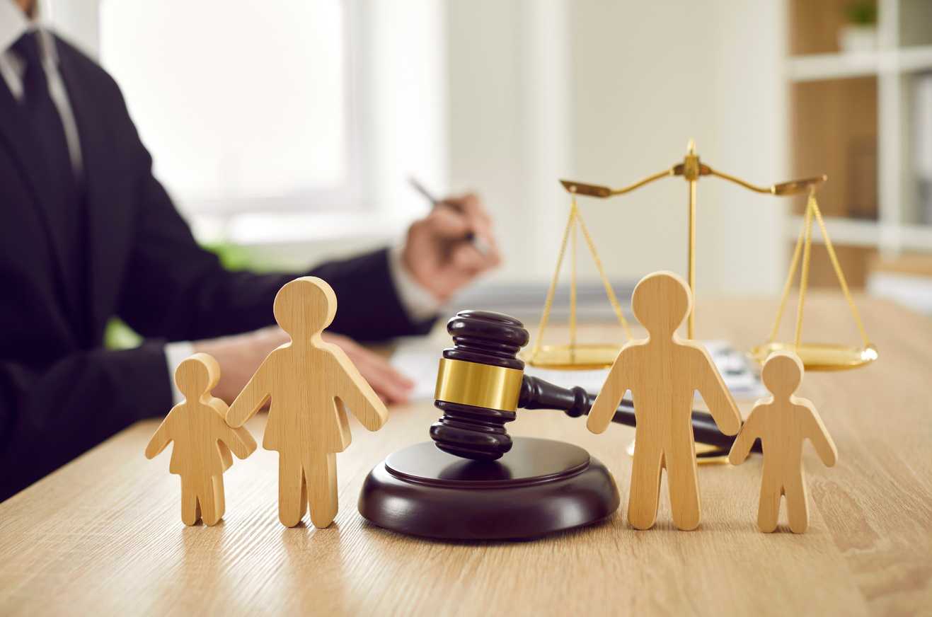 Gavel and  Figures on Judge's Table Illustrating Concept of Divorce and Child Custody