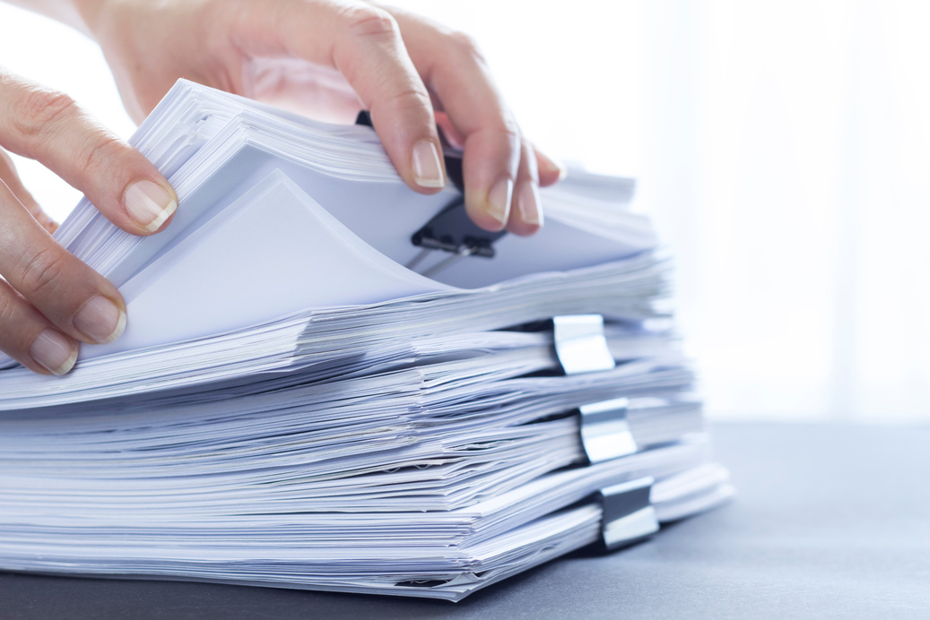 Stack of office paper documents. Business financial reports.